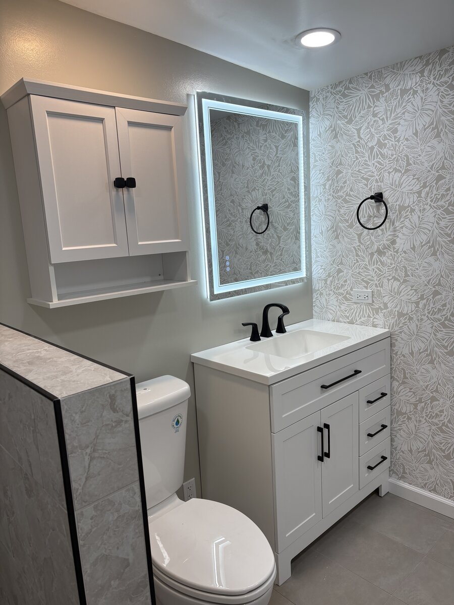 Completed bathroom with white vanity, LED mirror, and modern fixtures